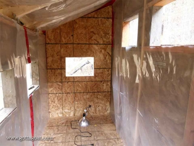 Insulation and plywood being installed in the coop